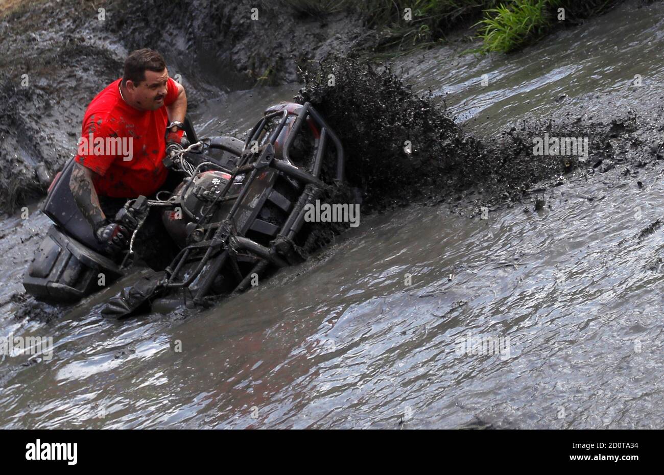 A man drives his vehicle through mud during the Off Road Festival in  Somogybabod, 165 km (