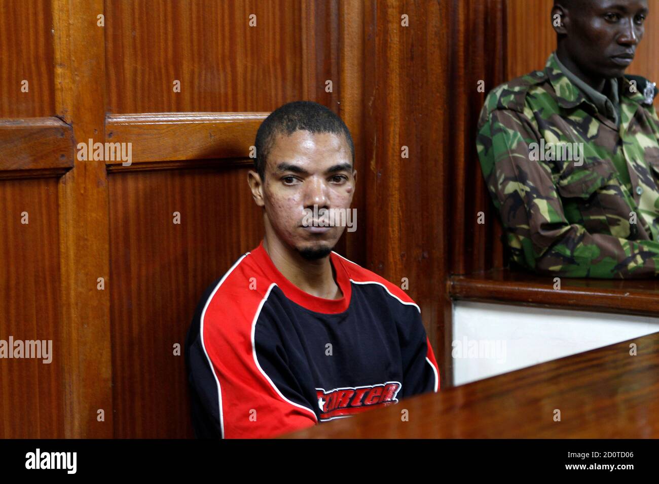 Jermaine Grant, a British citizen, sits inside the dock at the Milimani High Court in Kenya's capital Nairobi March 7, 2012. The trial against a Briton accused of Islamist extremist ties charged with five counts of robbery with violence and escaping from lawful custody started its hearing at the Kenya's High court in Nairobi. Evidence stated that at the time of his arrest four years ago, he was clad in Islamic dress normally worn by women. REUTERS/Thomas Mukoya (KENYA - Tags: CRIME LAW) Stock Photo
