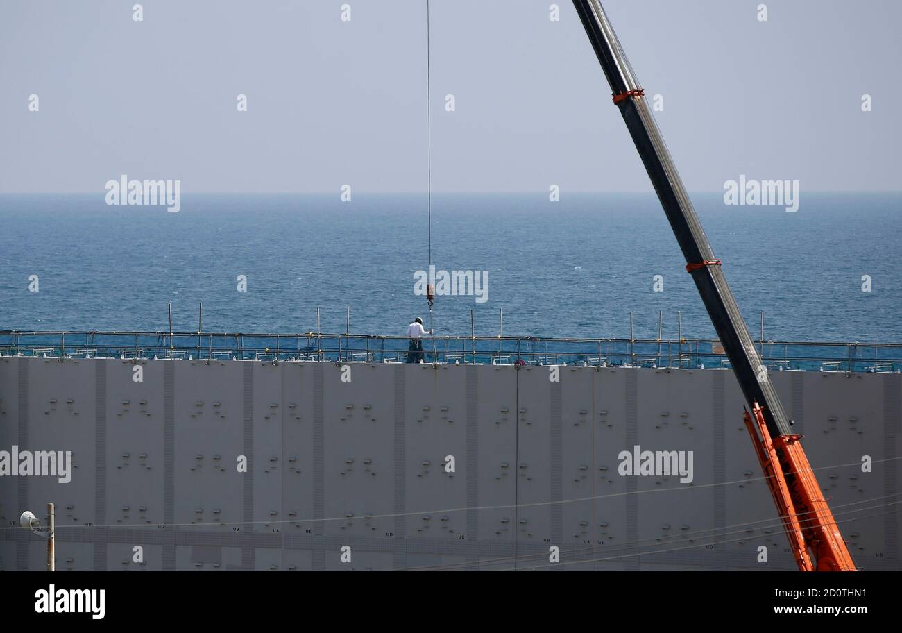 A Construction Worker Stands On An 18 Meter 59 Ft High And 1 6 Km 1 Mile Long Tsunami Defence Wall At Chubu Electric Power Co S Hamaoka Nuclear Power Station In Omaezaki Shizuoka Prefecture