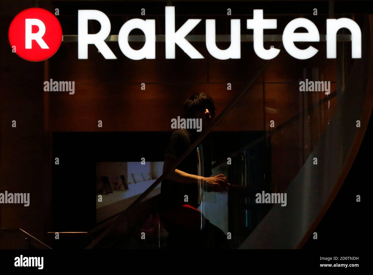 A Staff Of Rakuten Cafe Is Seen Under A Logo Of Rakuten Inc At A Shopping District In Tokyo August 4 14 Japan S Largest E Commerce Company Rakuten Inc Posted A 9 9 Percent A Staff Of Rakuten Cafe Is Seen Under A Logo Of Rakuten Inc At A Shopping District In Tokyo August 4 14 Japan S Largest E Commerce Company Rakuten Inc Posted A 9 9 Percent