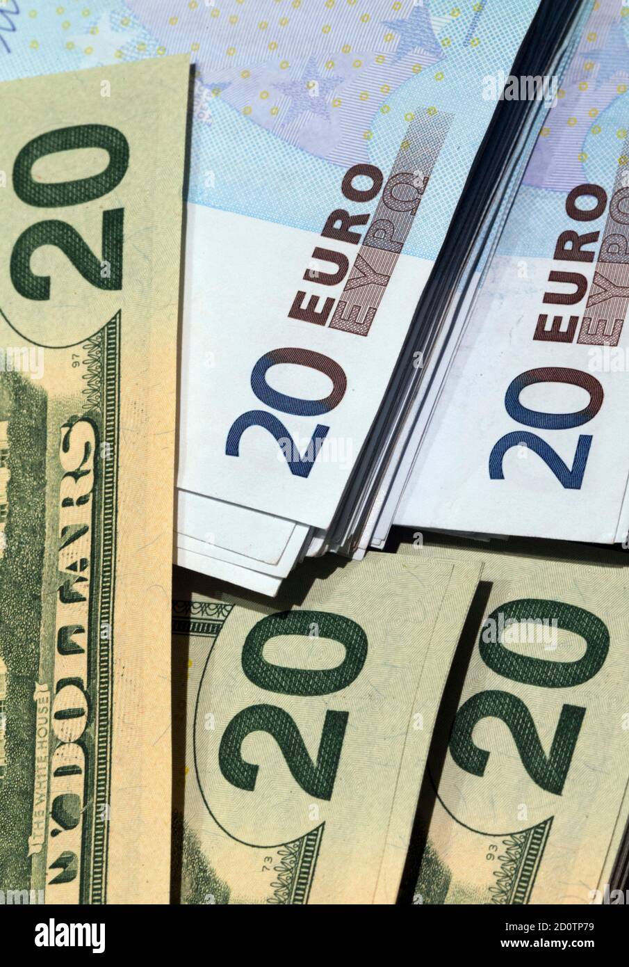 U.S. dollars and euros banknotes are seen in this illustration photo taken  at a change bureau in Paris, October 28, 2014. The global economy will  gradually improve over the next two years