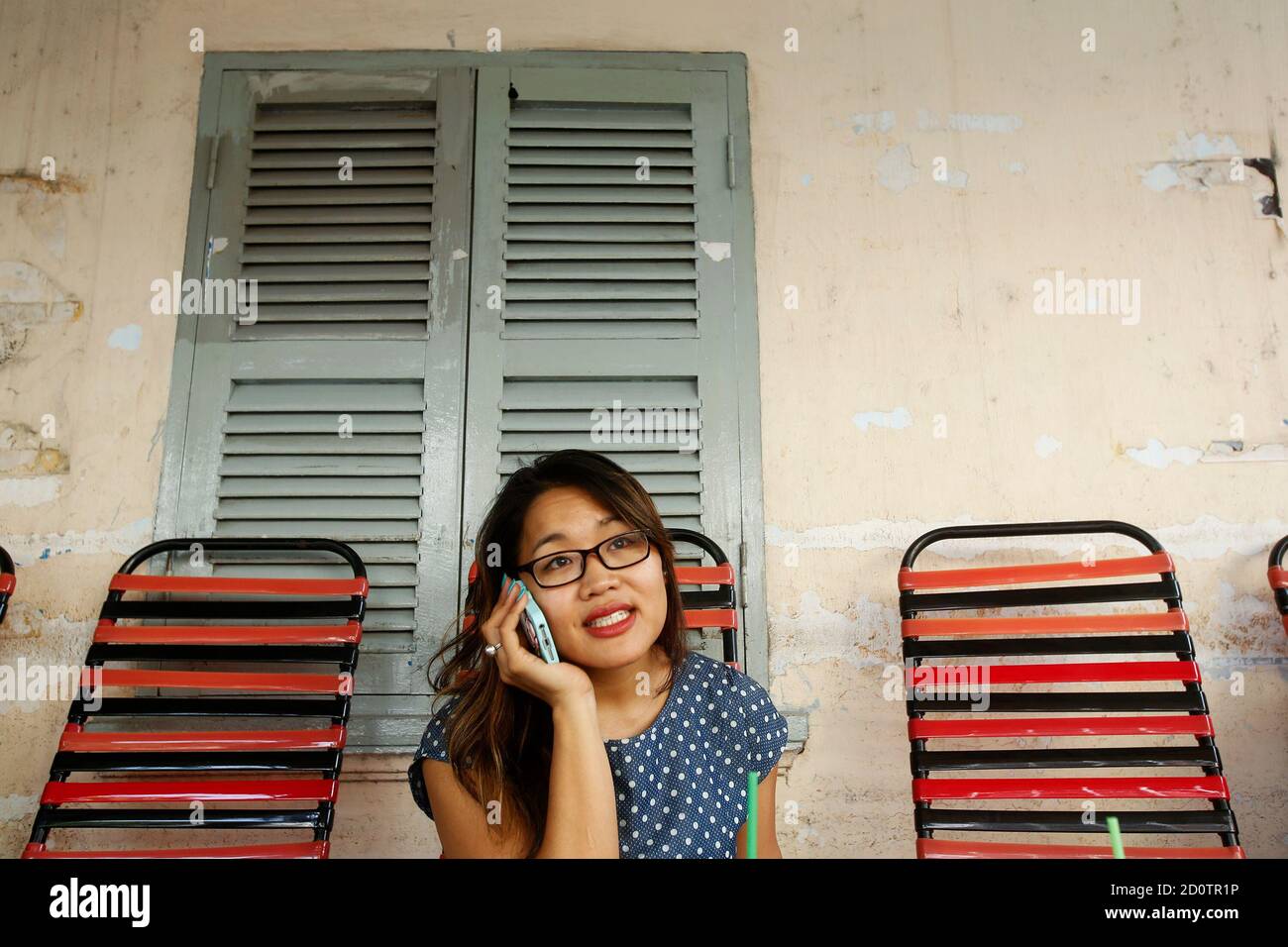 Film producer Jenni Trang Le talks on phone at a cafe in Ho Chi Minh City  March 9, 2015. Jenni Trang Le has made her mark in the Vietnamese film  industry, producing