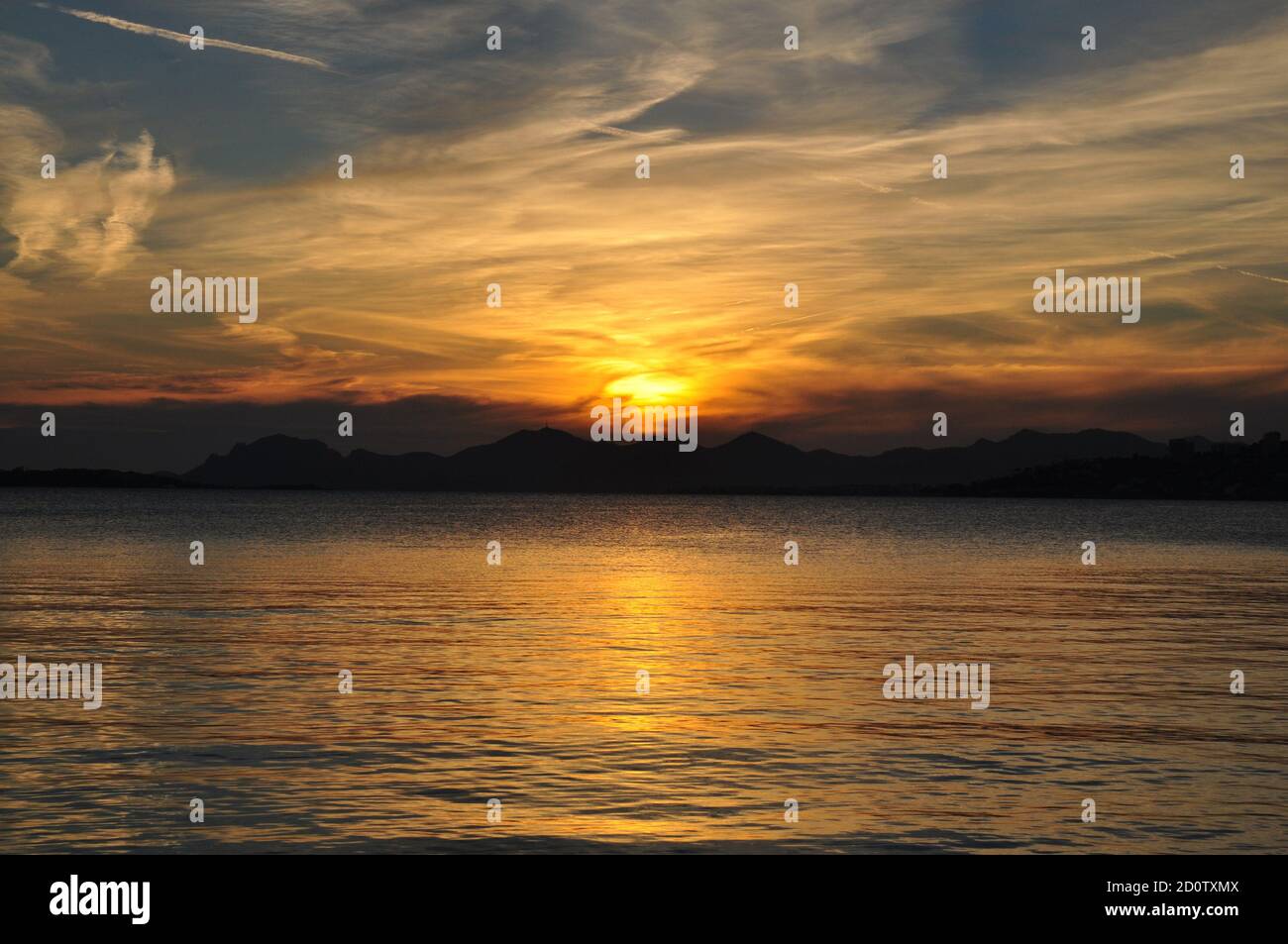 France, french riviera, sunset on Esterel massive seen from Juan les Pins beach with its mamgnificent colors and reflections on the mediterranean sea. Stock Photo