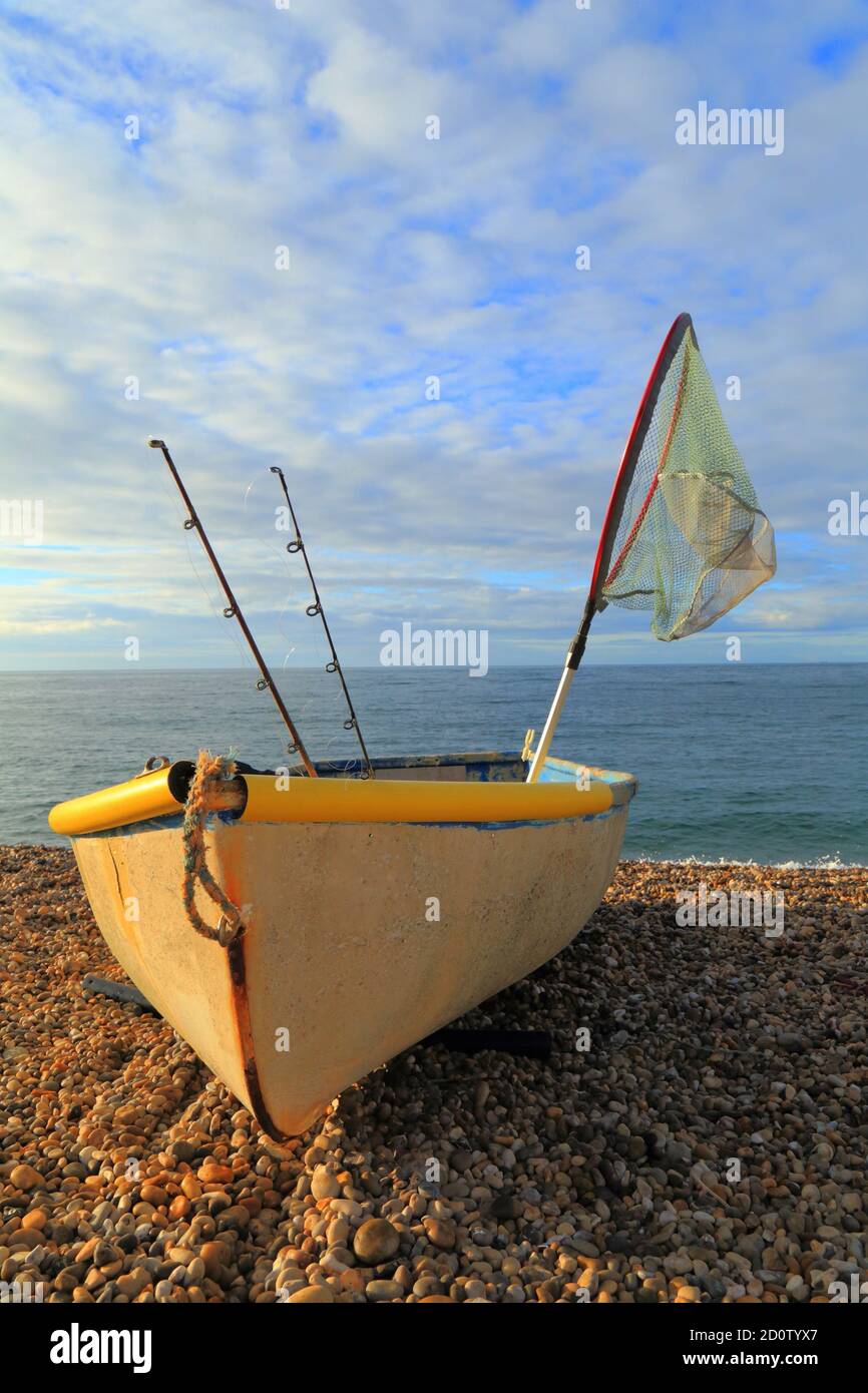 https://c8.alamy.com/comp/2D0TYX7/small-fishing-boat-with-rods-and-net-on-the-pebbles-beach-near-village-of-beer-devon-2D0TYX7.jpg