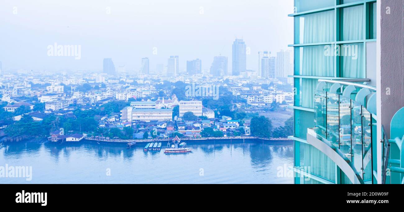 Bangkok skyline and Chao Phraya River in the morning, wideness view from balcony of room on high-rise modern glass residential building. Stock Photo