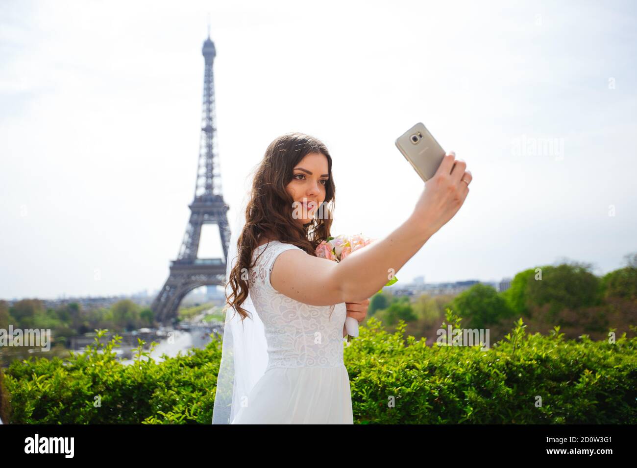 young woman walks in white lace dress, high-heeled shoes, Paris, Stock Photo