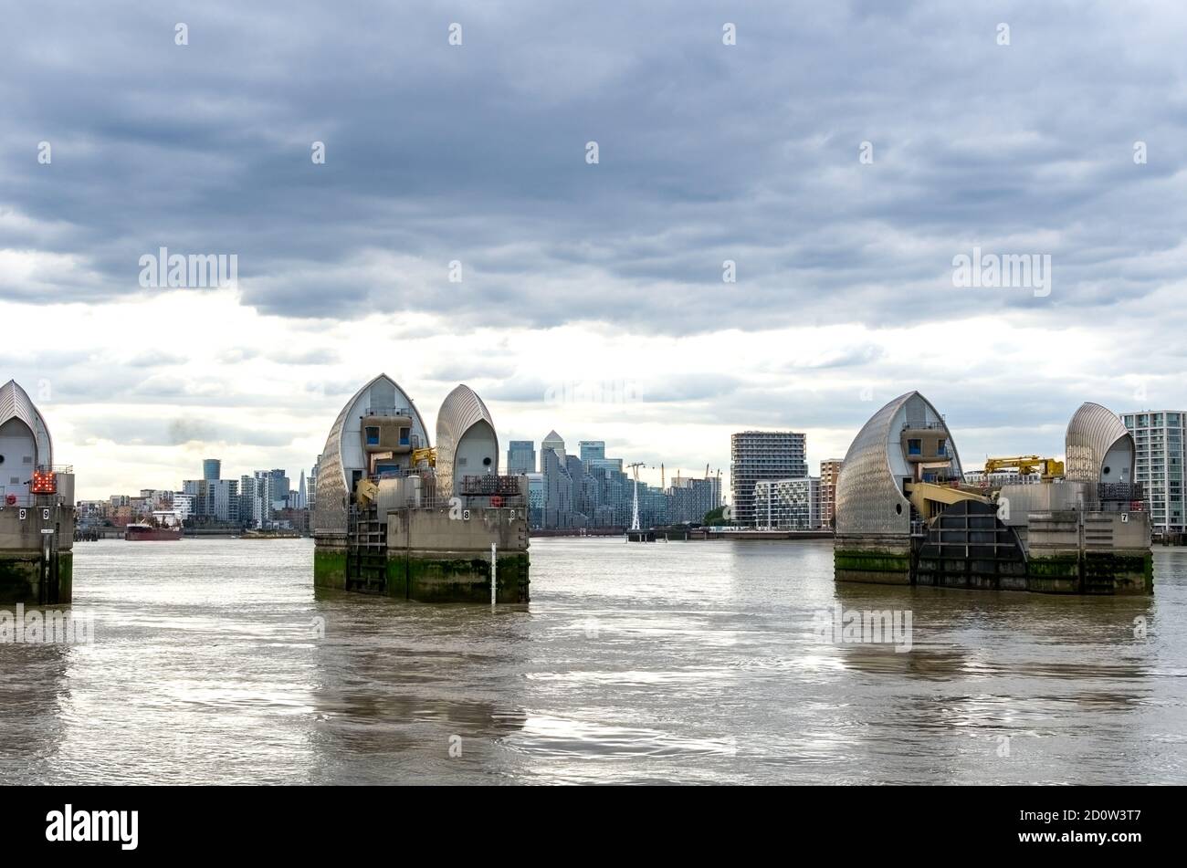 Thames Barrier on the River Thames against the Canary Wharf skyline ...