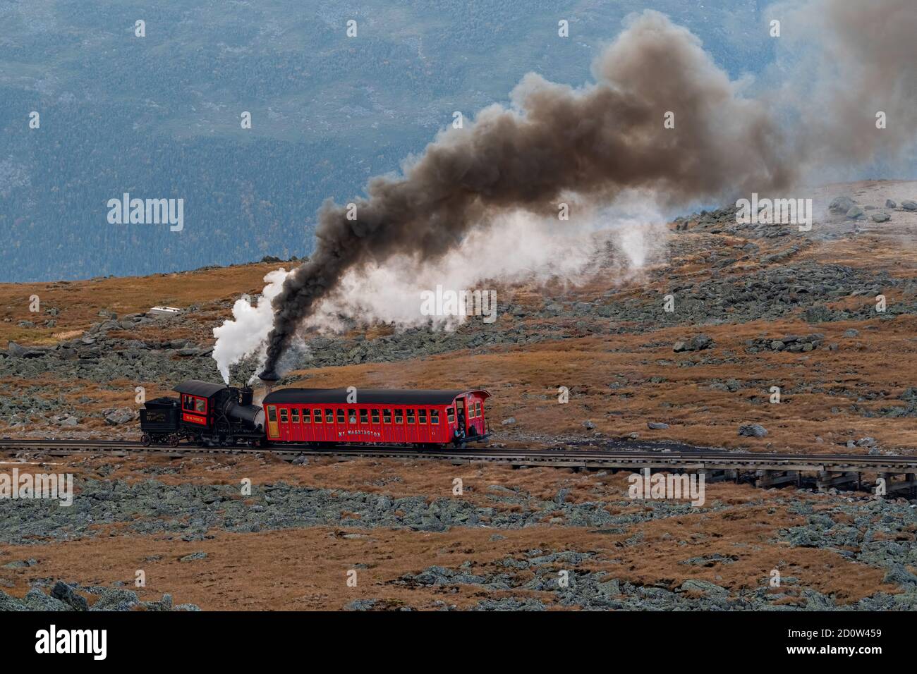 The old steam train heads up the cog railway to the summit of Mount Washington, New Hampshire, USA. Stock Photo