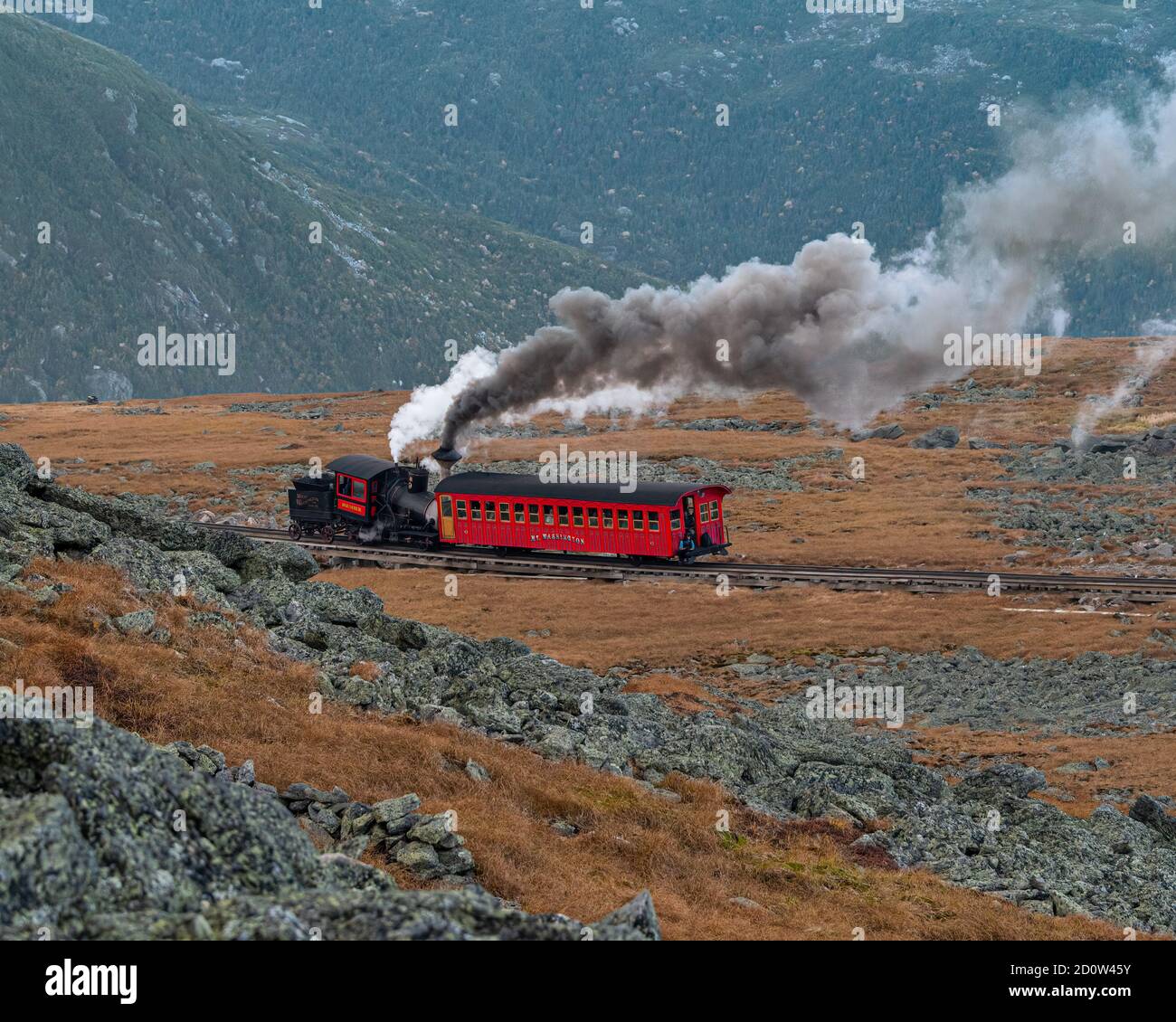 The old steam train heads up the cog railway to the summit of Mount Washington, New Hampshire, USA. Stock Photo