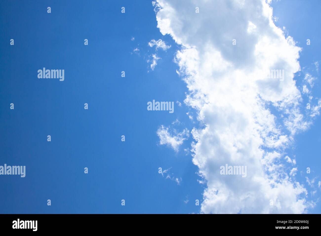 White fluffy clouds in a bright blue sky on a sunny day Stock Photo - Alamy