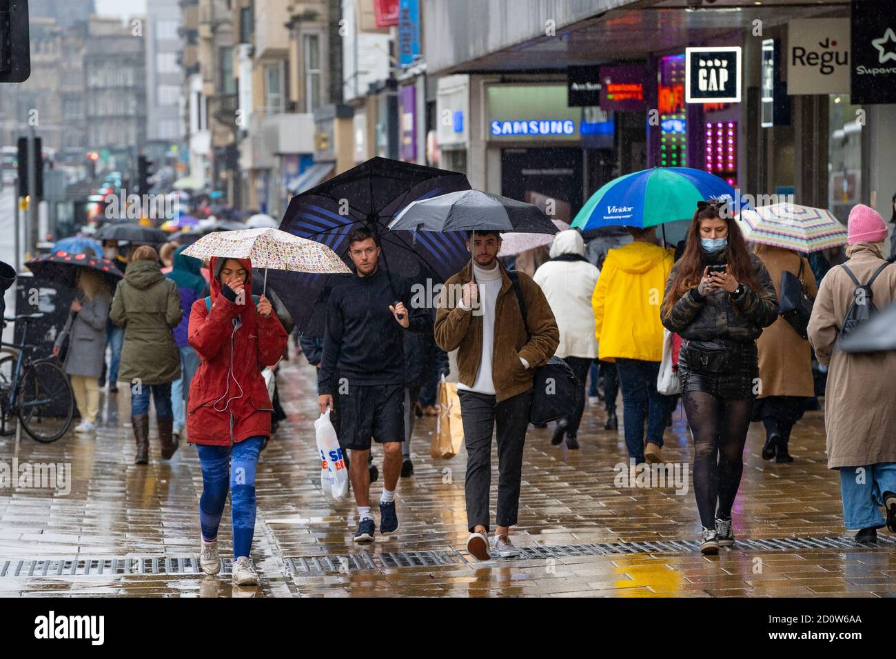 Edinburgh, Scotland, UK. 3 October, 2020. An amber rainfall warning for the east of Scotland did not deter many shoppers from walking along Princes Street in Edinburgh today. Persistent heavy rain fell throughout the morning and afternoon. Iain Masterton/Alamy Live News Stock Photo