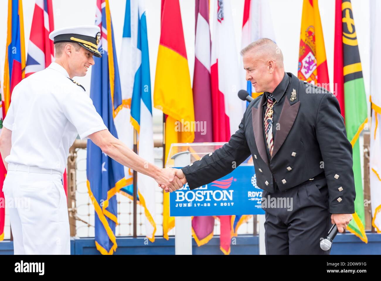 Boston, Massachusetts. 13th June, 2017. Commander Ethan Rule shaking hands with Sgt Daniel Clark at Sail Boston ceremonies on the USS Whidbey Island. Stock Photo