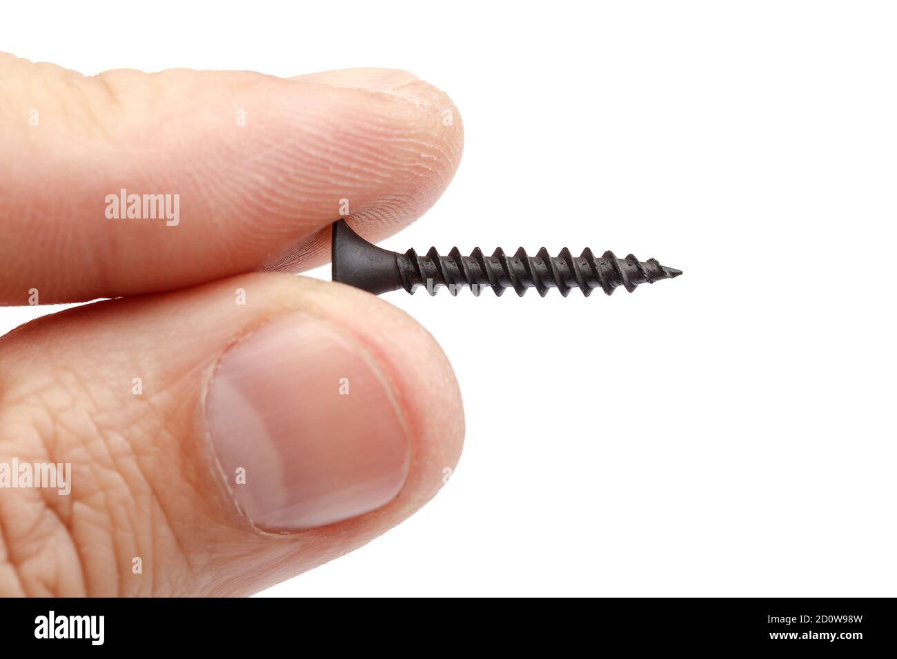 A metal self-tapping screw in the hand, isolated on a white background. Stock Photo