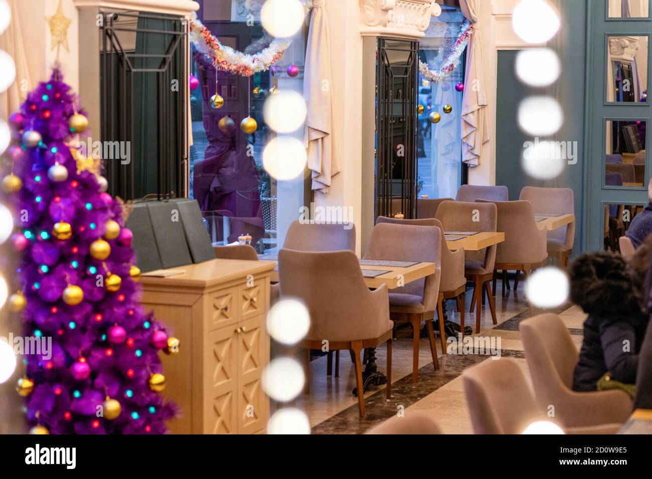 Purple Christmas tree in the restaurant interior Stock Photo