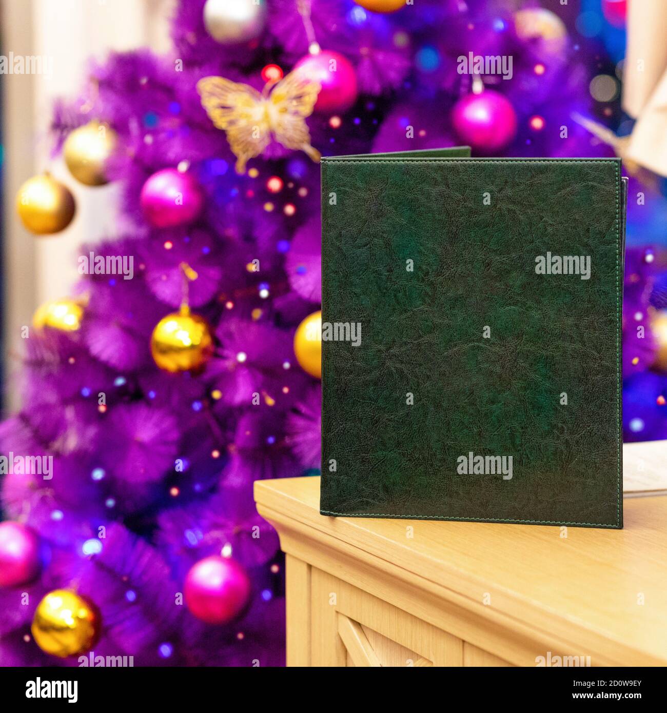 Restaurant menu book with purple Christmas tree close up Stock Photo