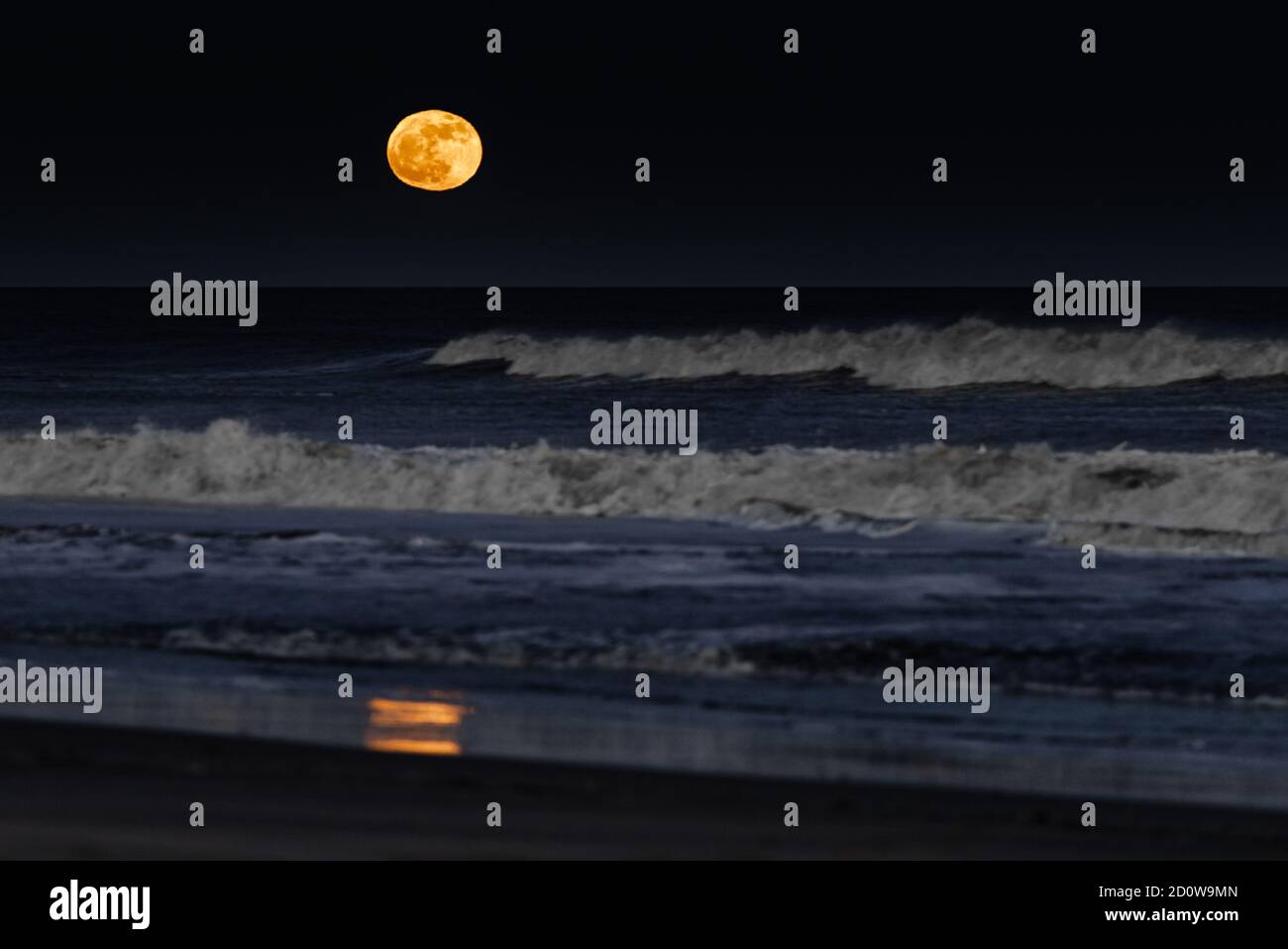 The moon rising over the beach at Assateague Island National Seashore in Maryland, USA Stock Photo