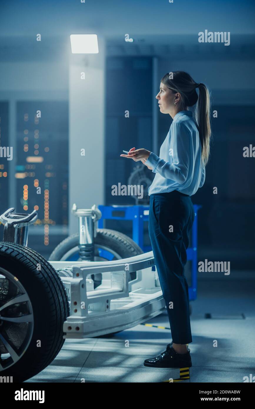 Automotive Design Engineer Thinking About Electric Car Chassis Prototype. In Innovation Laboratory Facility Concept Vehicle Frame Includes Wheels Stock Photo