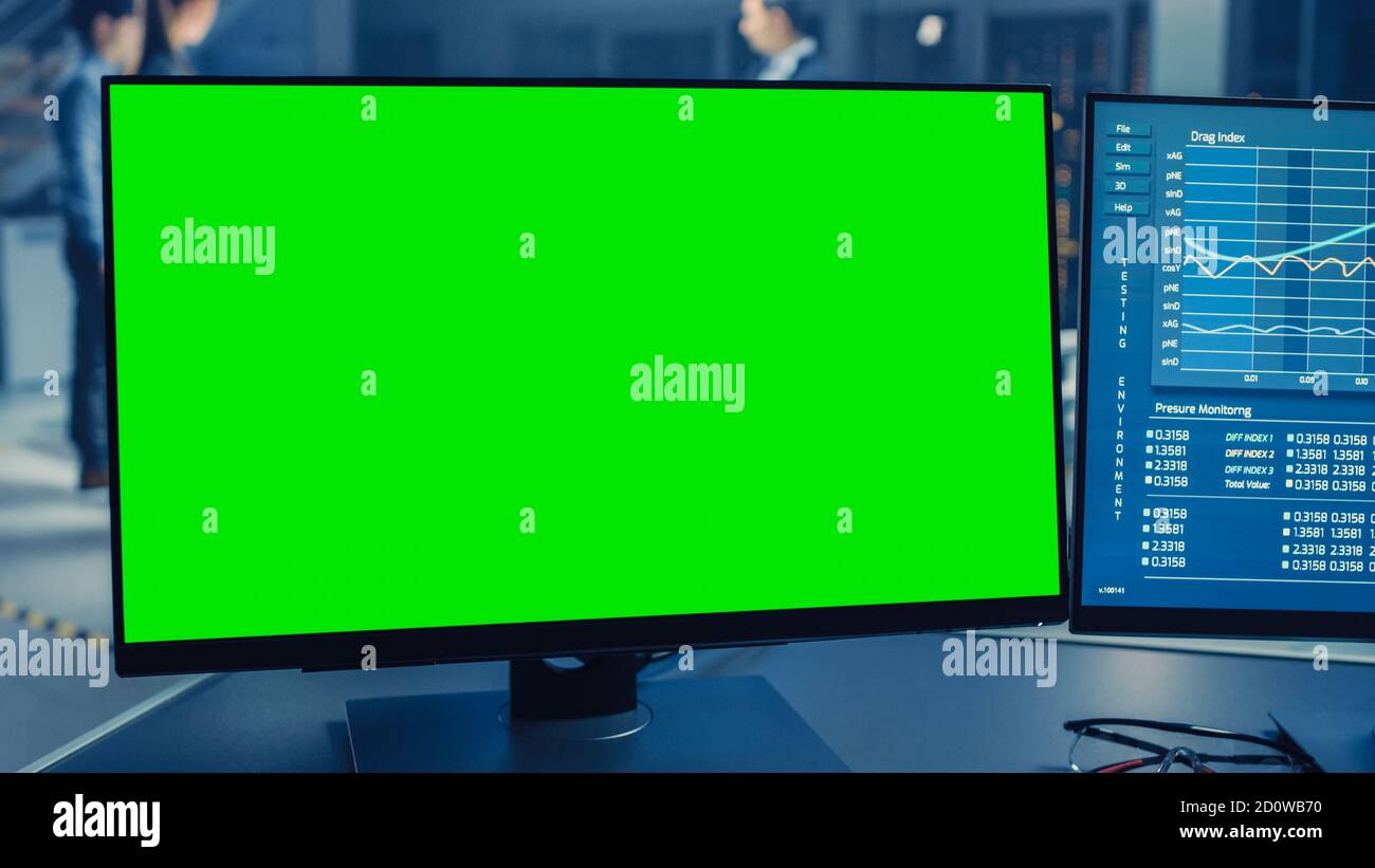 Professional Engineer Works on a Computer with Green Screen Mock Up and