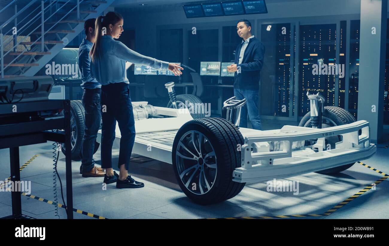 Automotive Design Engineers Talking while Working on Electric Car ...