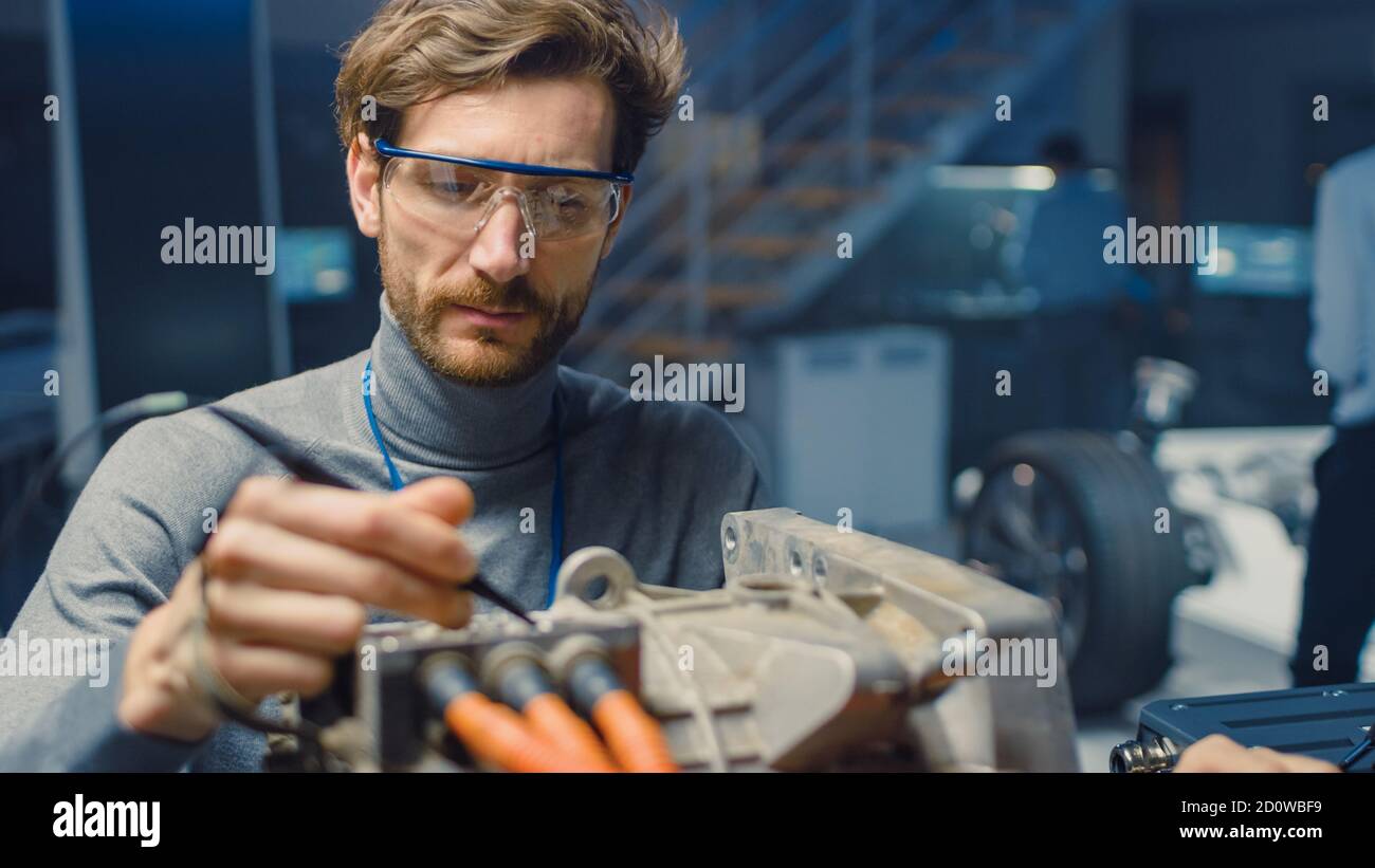 Professional Automotive Engineer in Glasses with a Computer and