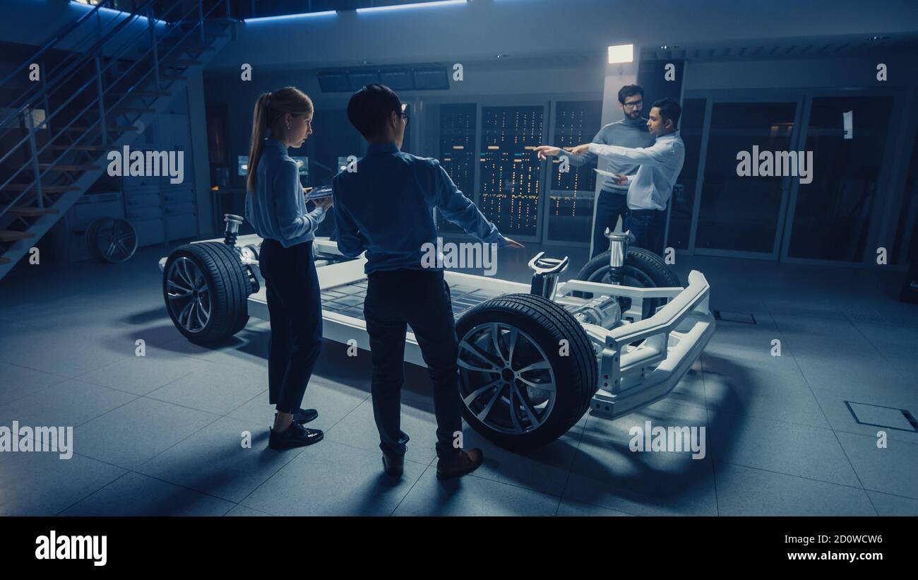 Team of Automotive Engineers Discussing and Designing Electric Car ...