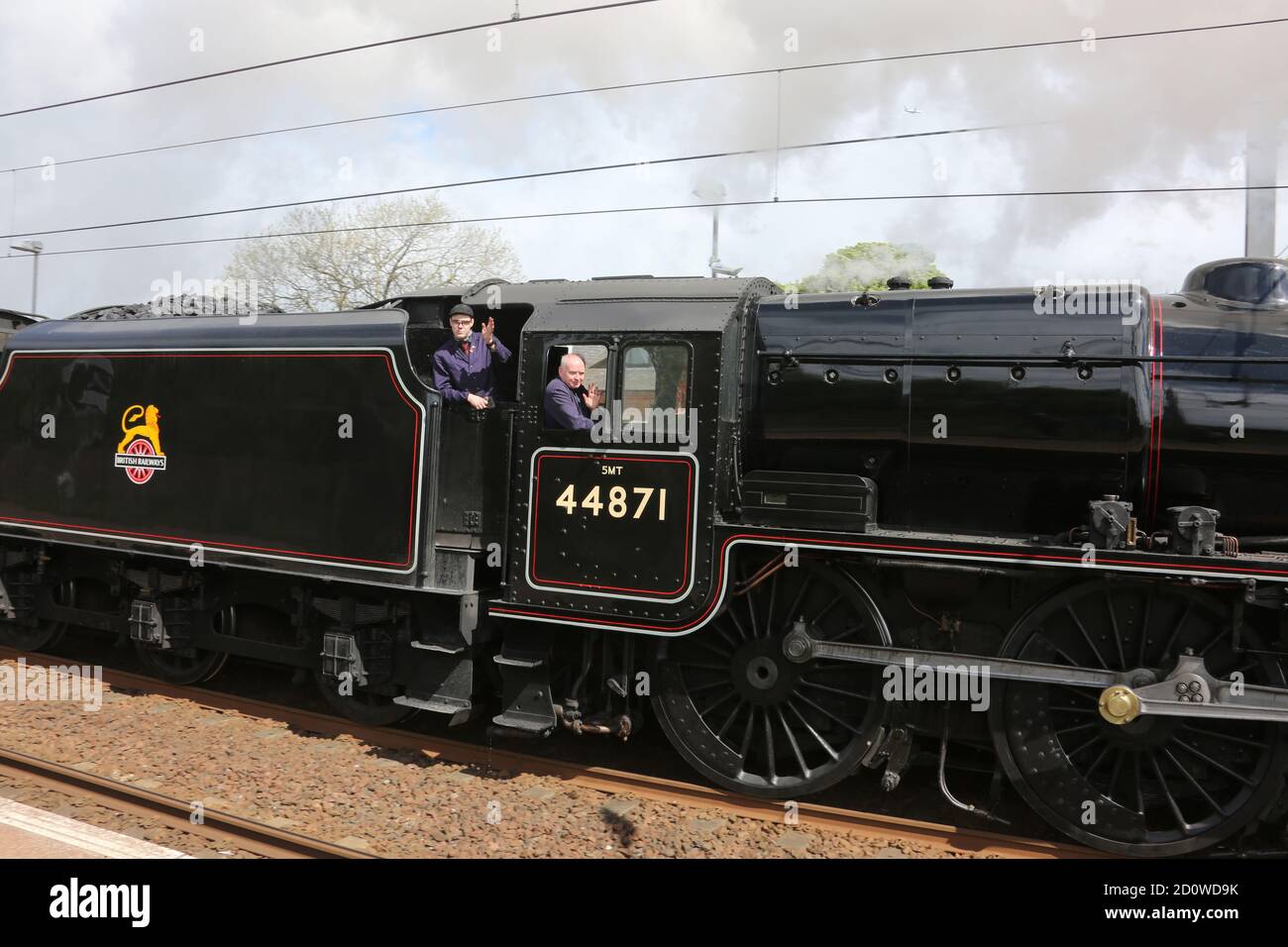 Ayr ,02 May 2019. Rail Tour with Steam engiine travelling through Newton on Ayr station, Ayr, Ayrshire, Scotland. The Great Britain X11 on head board. LMS Black Five 44871 driver waving from the cab footplate Stock Photo