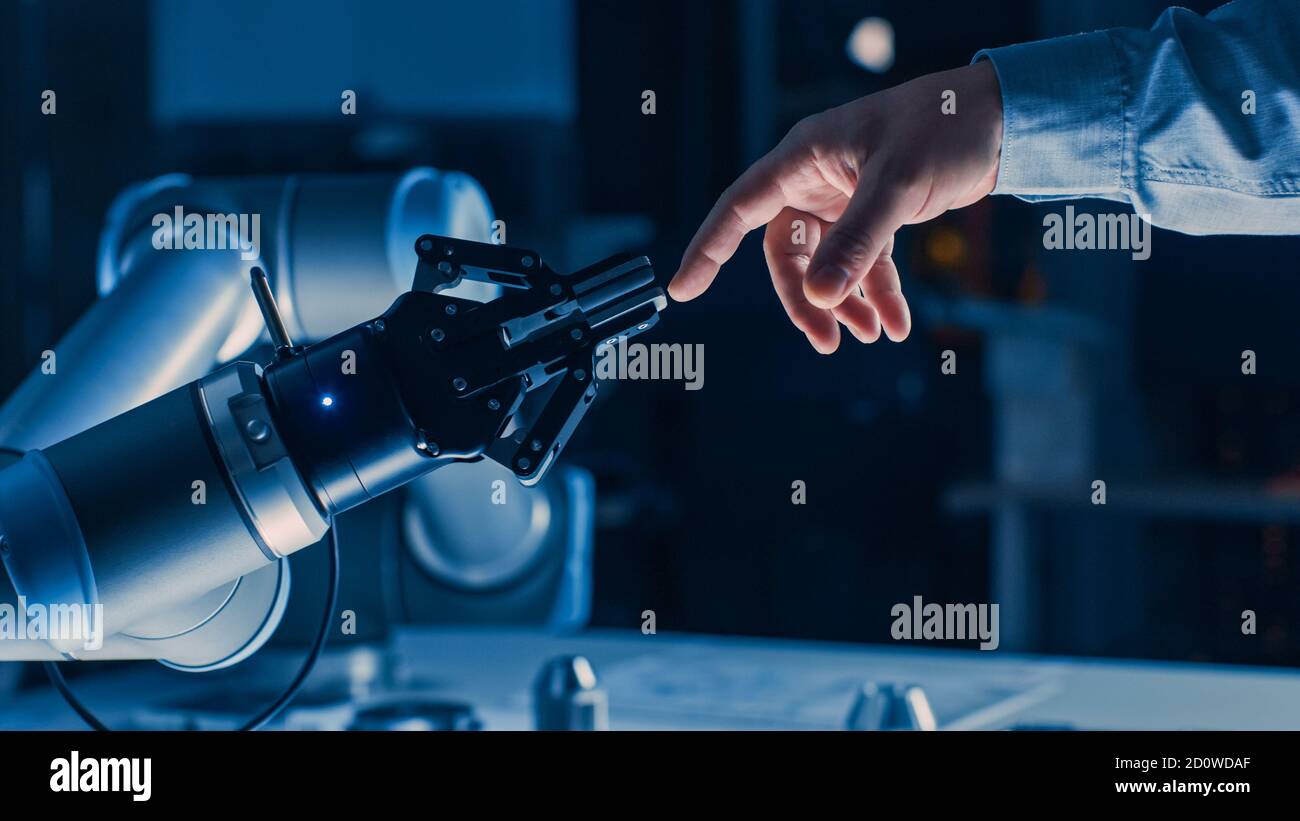 Futuristic Robot Arm Touches Human Hand in Humanity and Artificial ...