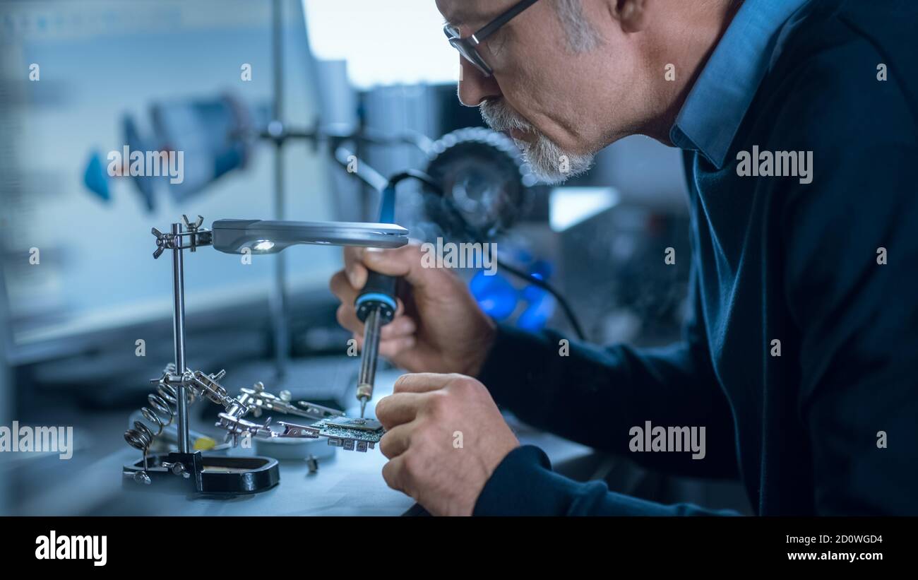 Portrait of Focused Middle Aged Engineer in Glasses Working with High ...