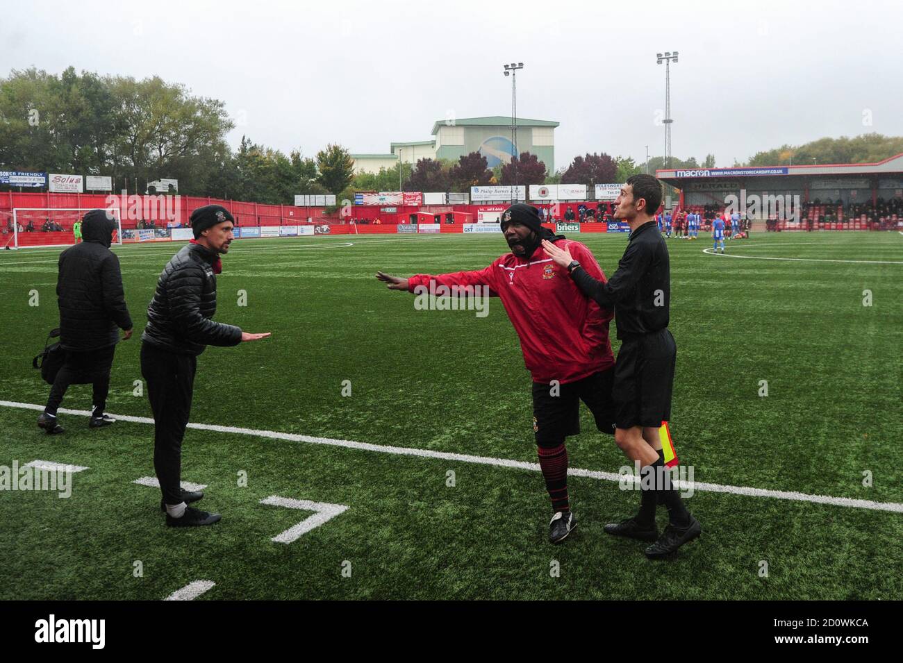 Tamworth manager Andrew Danylyszyn talks to a linesman regarding an incident on the pitch during the FA Cup Second Round Qualifying match at The Lamb Ground, Tamworth. Stock Photo