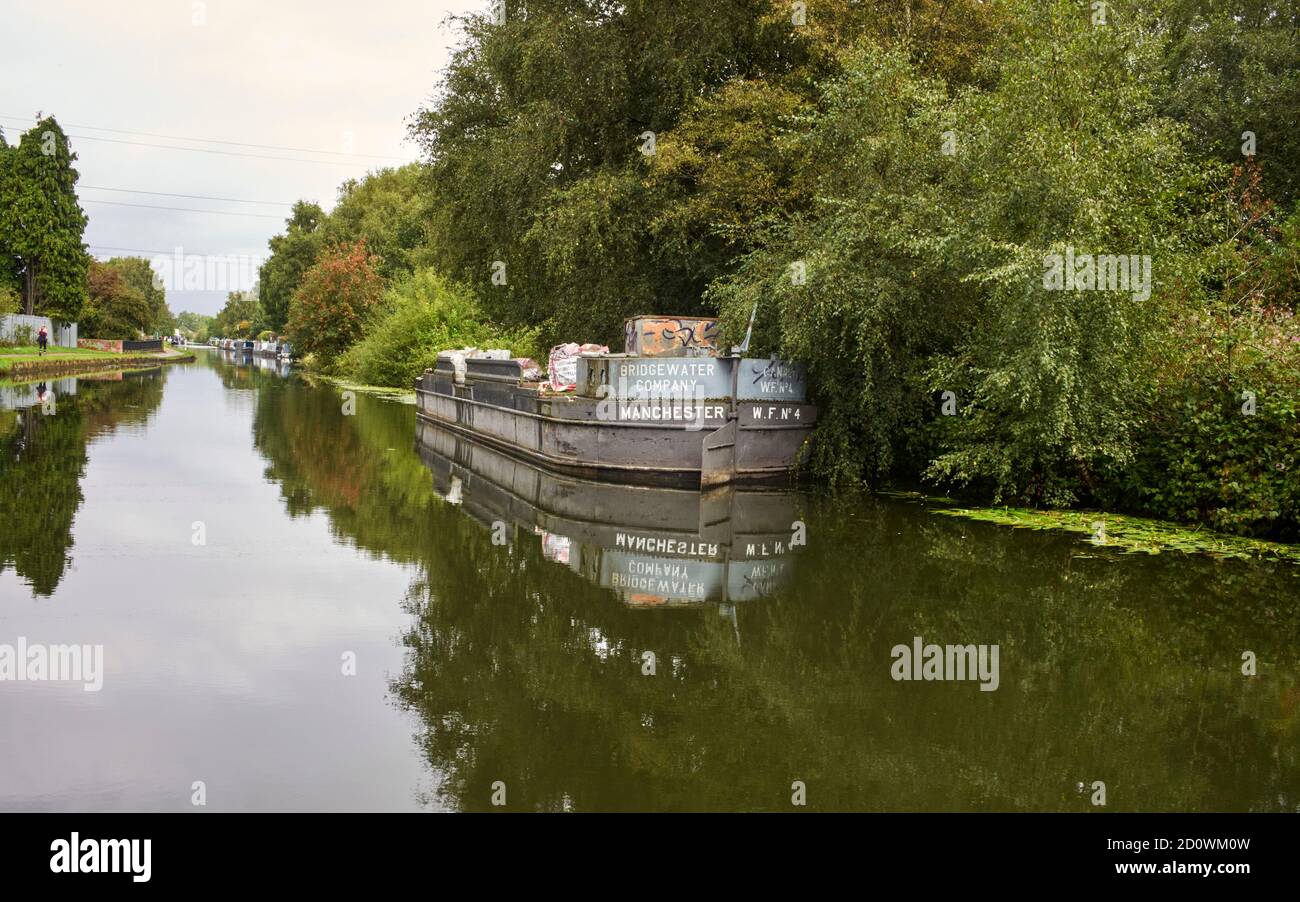 A large widebeam maintenance barge moored at Sale, Manchester on the privately owned Bridgewater Canal Stock Photo