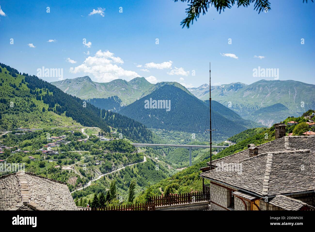 Spring landscape high angle view, roofs and valley from town of Metsovo, Epirus, Greece. The establishment is popular winter ski Greek resort with old Balkans style houses Stock Photo