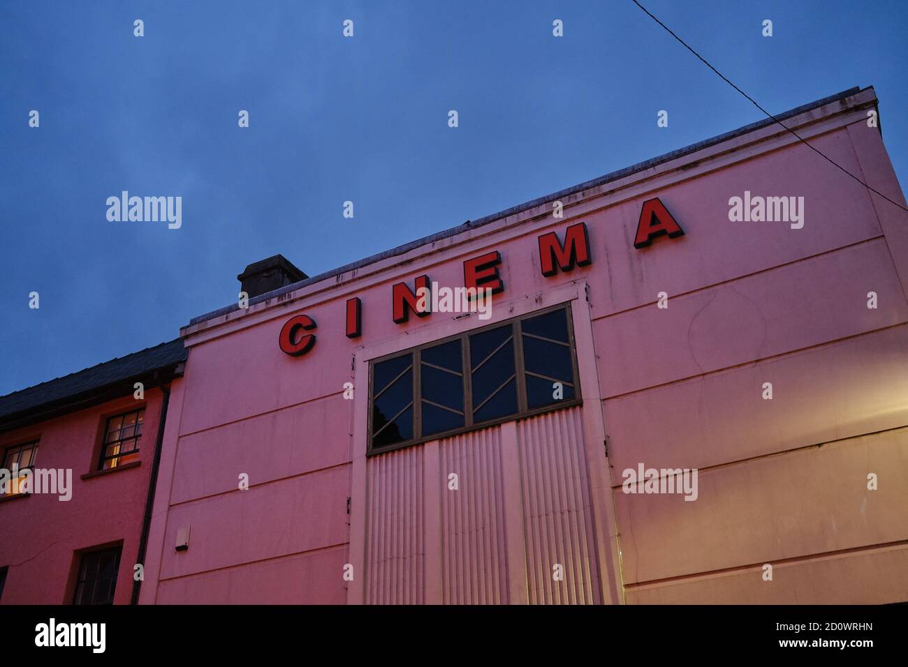 wall with pink cinema lettering at nightfall Stock Photo