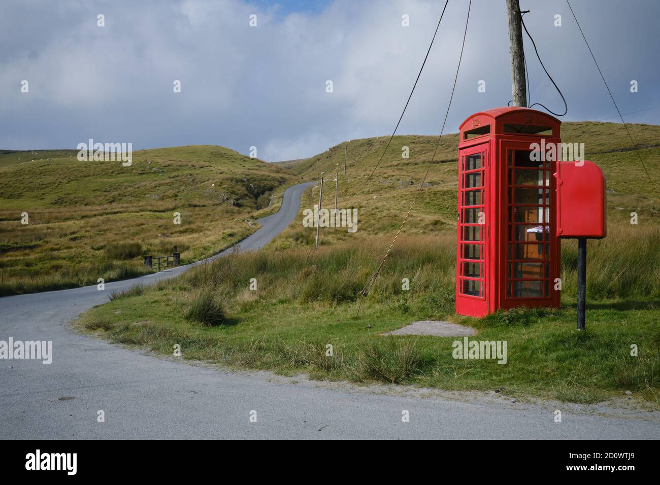 telephone kiosk and letter box in a remote landscape in Wales Stock Photo