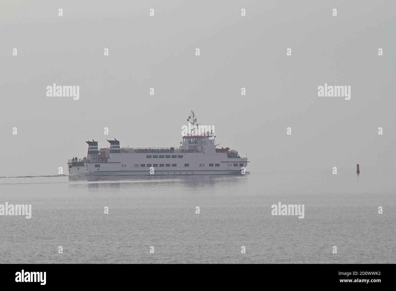Ferry on as misty calm sea on a grey and misty day Stock Photo