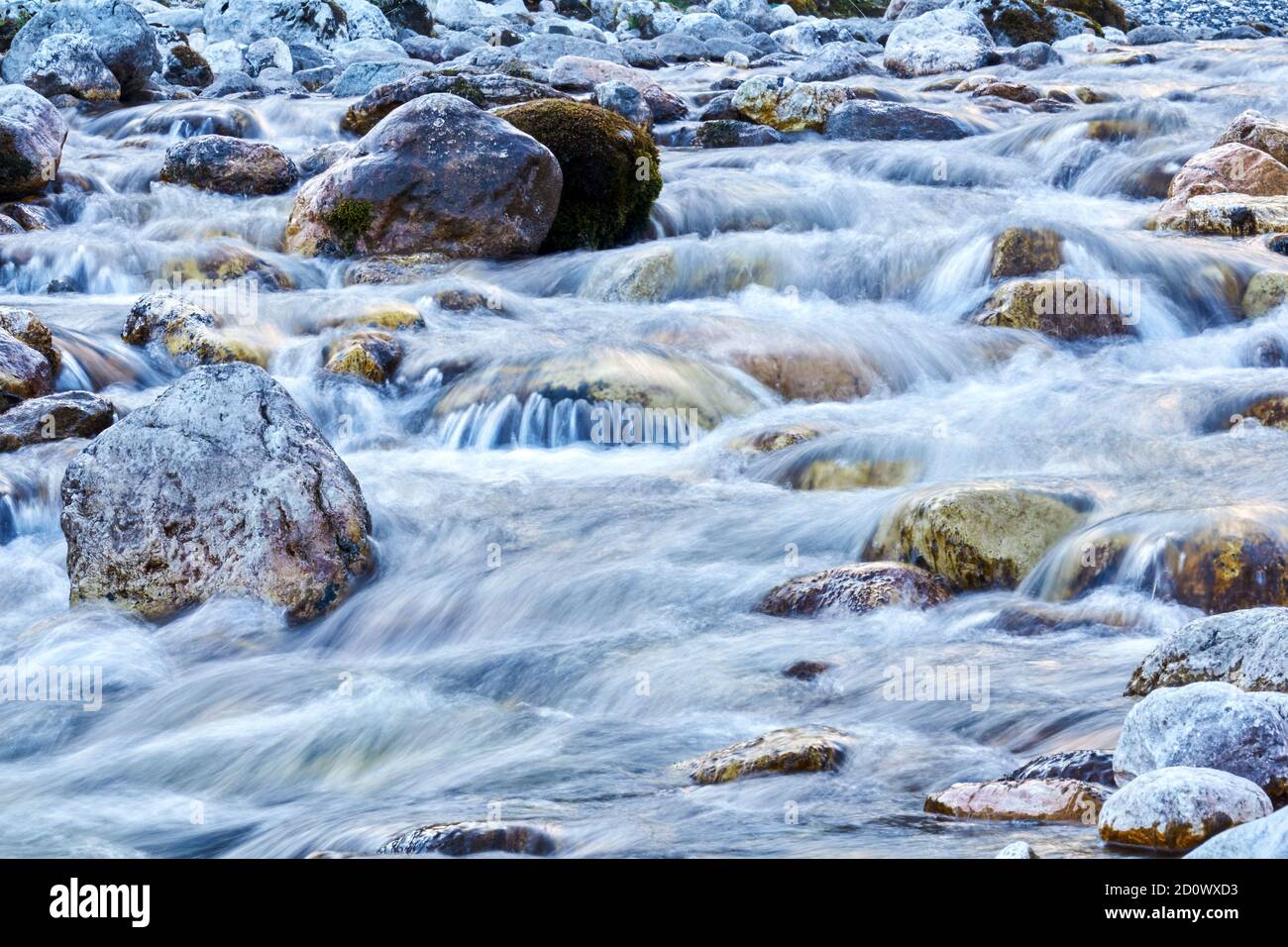 natural background - a rocky riffle on a clear mountain river close-up ...