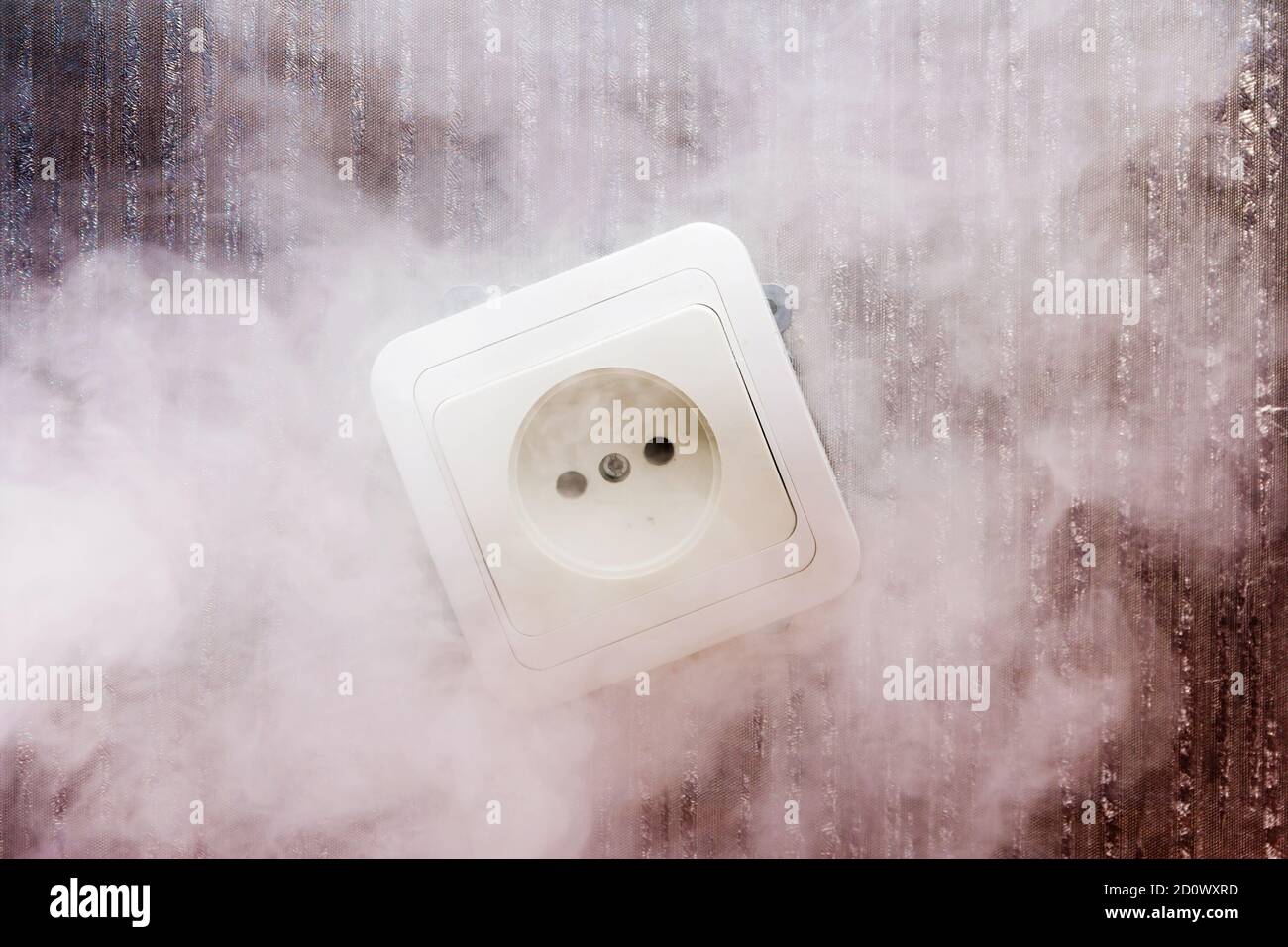 Smoke appeared from a faulty electrical outlet due to a short circuit