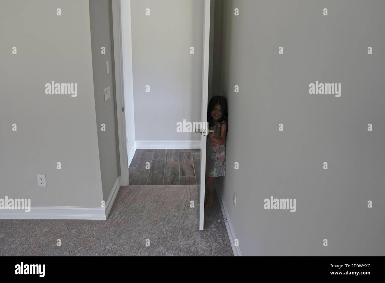 Girl playing hide and seek Stock Photo