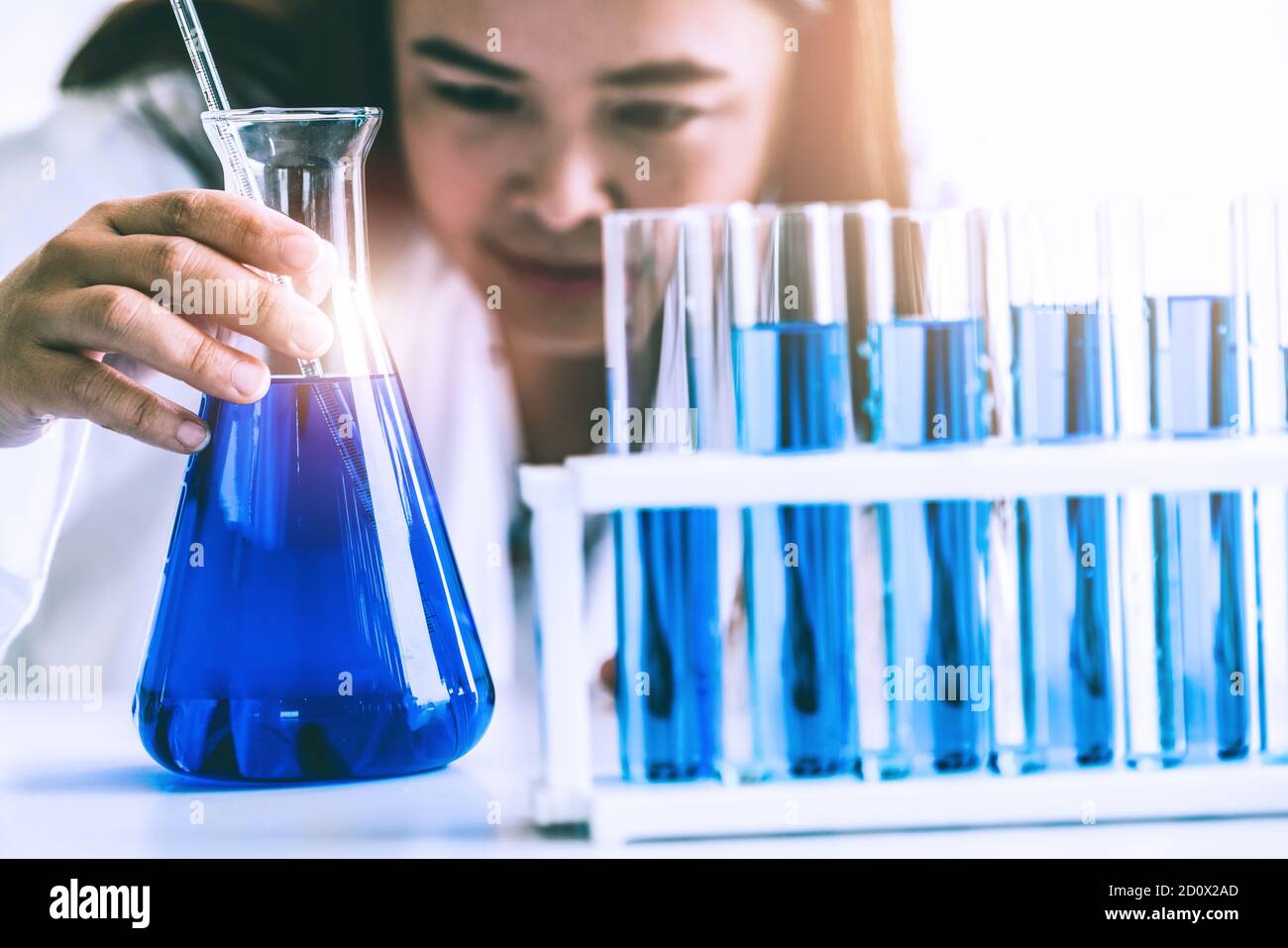 Woman scientist working in laboratory and examining biochemistry sample