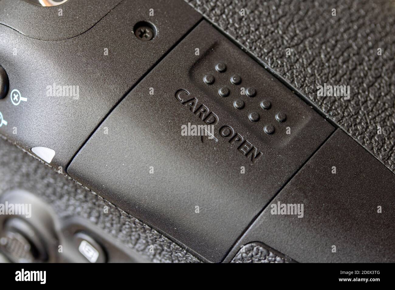 The slot of memory card in a digital camera. The closed door of data card of the digital camera. Stock Photo