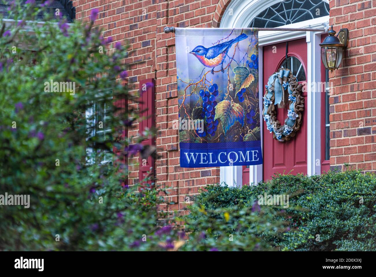 Welcome flag at the front door entrance to an upscale brick home in Lilburn (Metro Atlanta), Georgia. (USA) Stock Photo