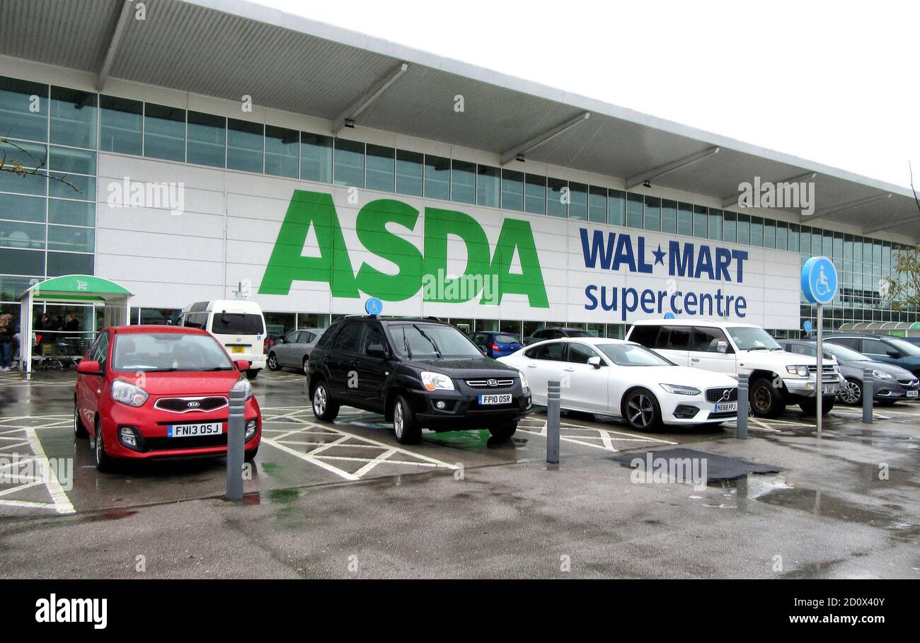 Cars are seen parked outside a large Asda and former owner Walmart's super-centres.UK's third biggest supermarket chain Asda has been sold by its US owner Walmart.Billionaire brothers Mohsin & Zuber Issa and private equity firm TDR Capital won the bidding war in a £6.8billion deal. The Blackburn based Issa brothers own EG Group, which they built from a single petrol station in 2001 to more than 6,000 sites around the globe and an annual turnover of £20billion. It will be the first time Asda has been in British ownership for over 20 years. Stock Photo