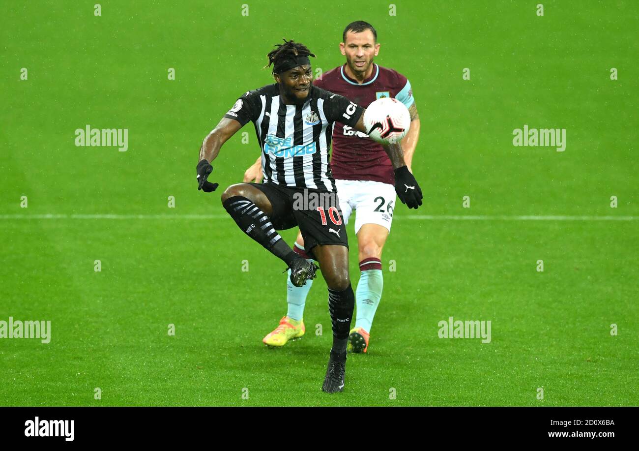 Newcastle United's Allan Saint-Maximin (left) and Burnley's Phil Bardsley battle for the ball during the Premier League match at St James' Park, Newcastle. Stock Photo