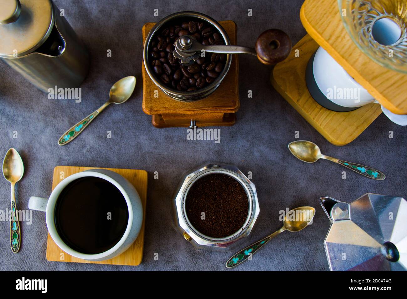 Coffee makers and beans, cup of coffee on the gray background Stock Photo
