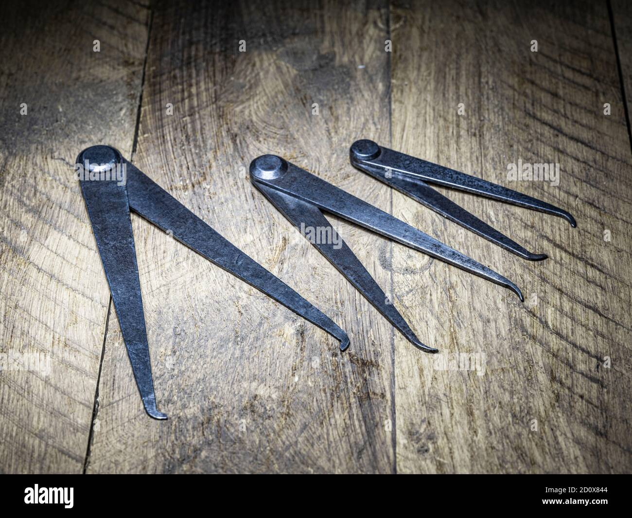 Set of three engineers odd leg callipers on timber flooring resting
