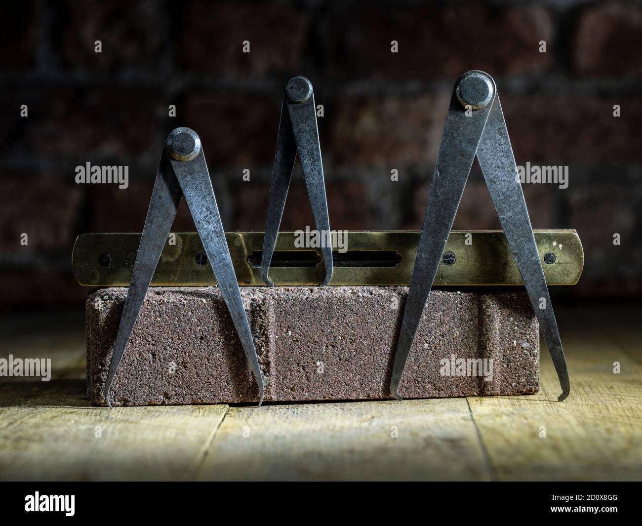 Set of three engineers odd leg callipers on timber flooring resting