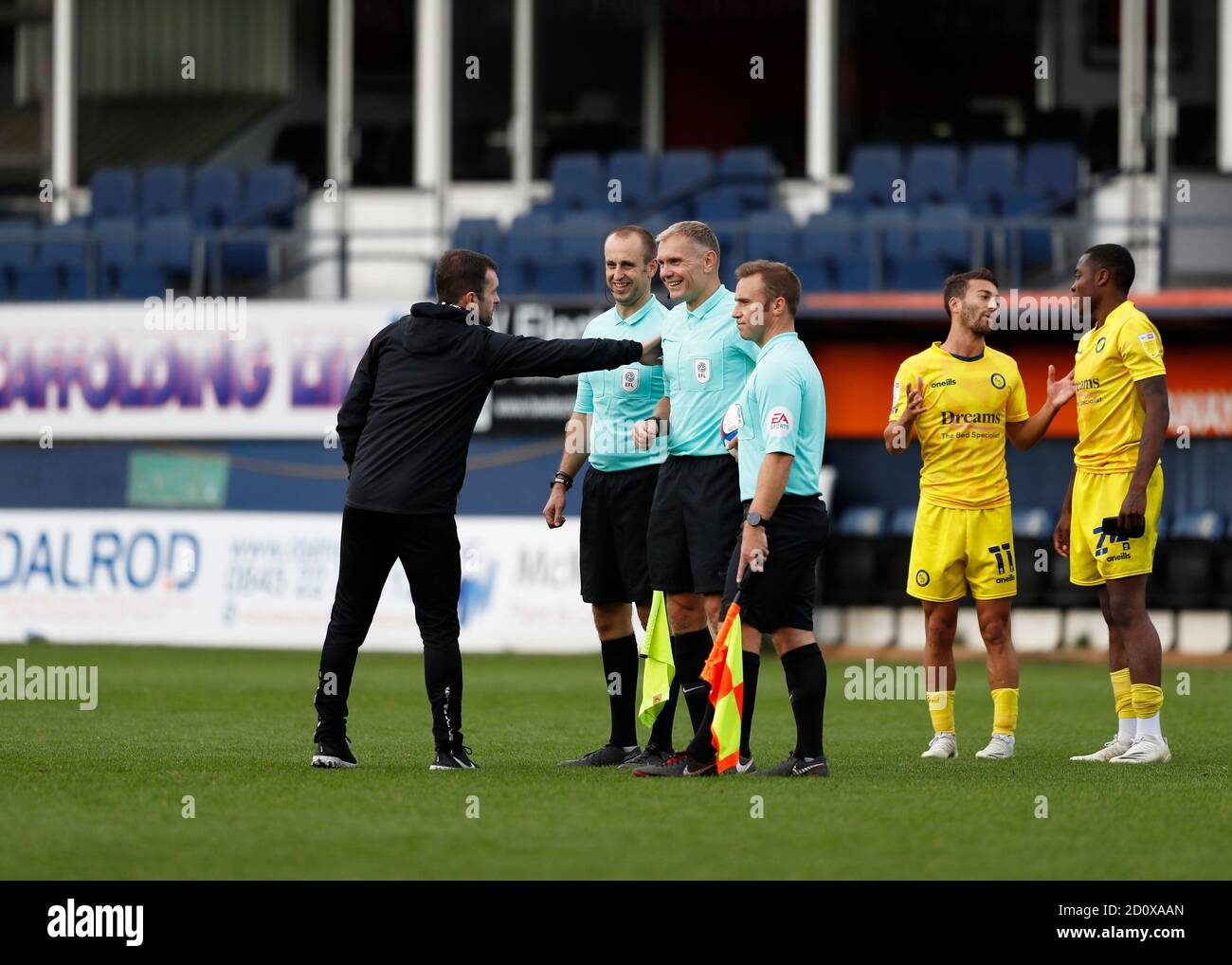 Kenilworth Road, Luton, Bedfordshire, UK. 3rd Oct, 2020. English Football League Championship Football, Luton Town versus Wycombe Wanderers; Luton Town Manager Nathan Jones gives a pat on the shoulder to Referee Graham Scott alongside Assistant Referee Henry Lennard with a disappointed Scott Kashket of Wycombe Wanderers talking to Dennis Adeniran of Wycombe Wanderers Credit: Action Plus Sports/Alamy Live News Stock Photo