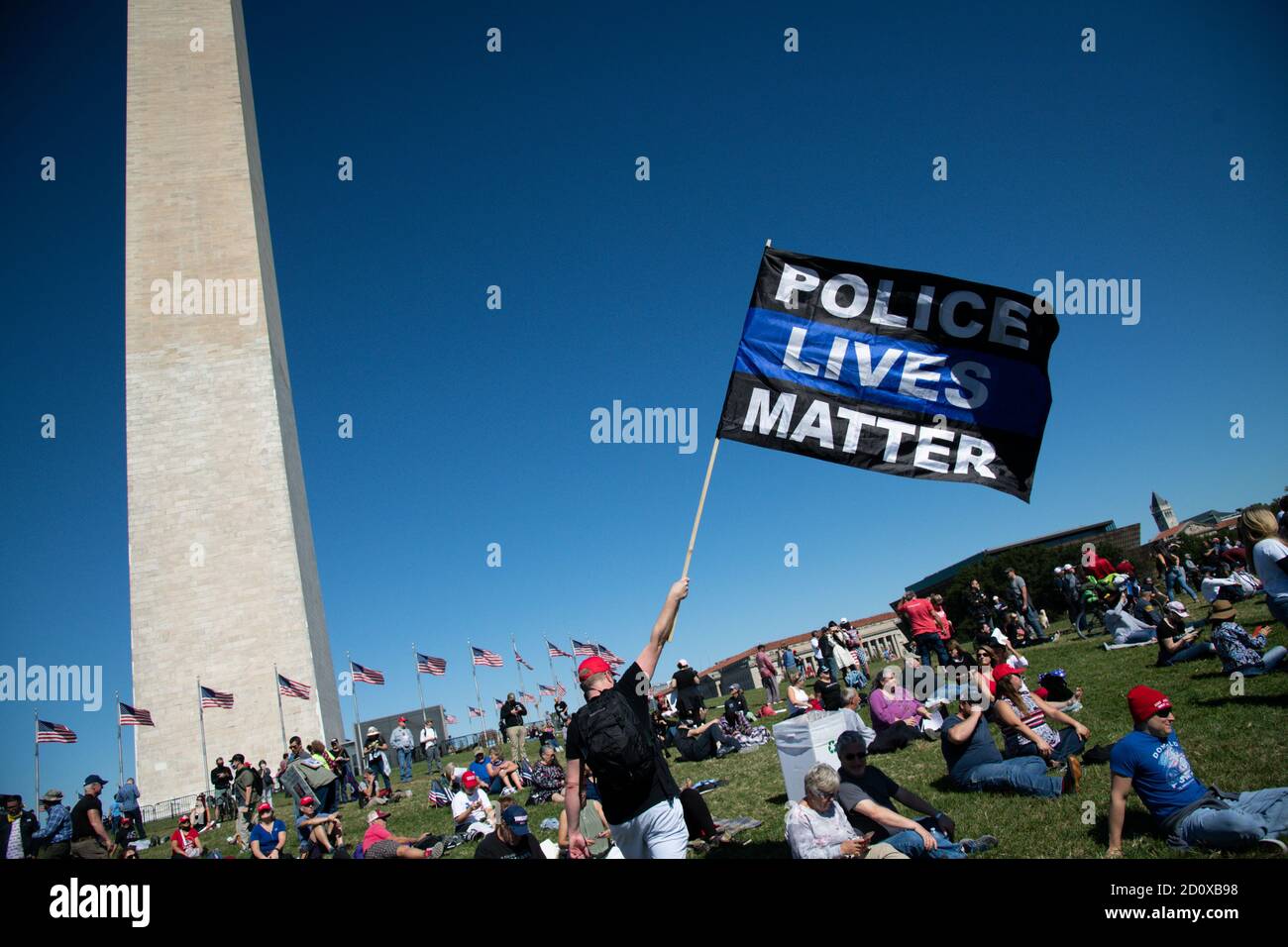 Washington, USA. 03rd Oct, 2020. A protester carries a Police Lives Matter flag near the Washington Monument, as part of the Unsilent March, in Washington, DC, on October 3, 2020, amid the coronavirus pandemic. The day after President Donald Trump's admittance to Walter Reed National Military Medical Center after contracting COVID-19, hundreds marched in support of the Walk Away movement and shared stories of leaving the Democratic Party. (Graeme Sloan/Sipa USA) Credit: Sipa USA/Alamy Live News Stock Photo