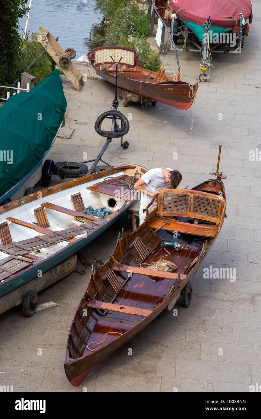 Richmond upon Thames, Surrey, England - September 02 2020: Boat Builders, working in front of the Richmond Bridge Boat Houses Stock Photo