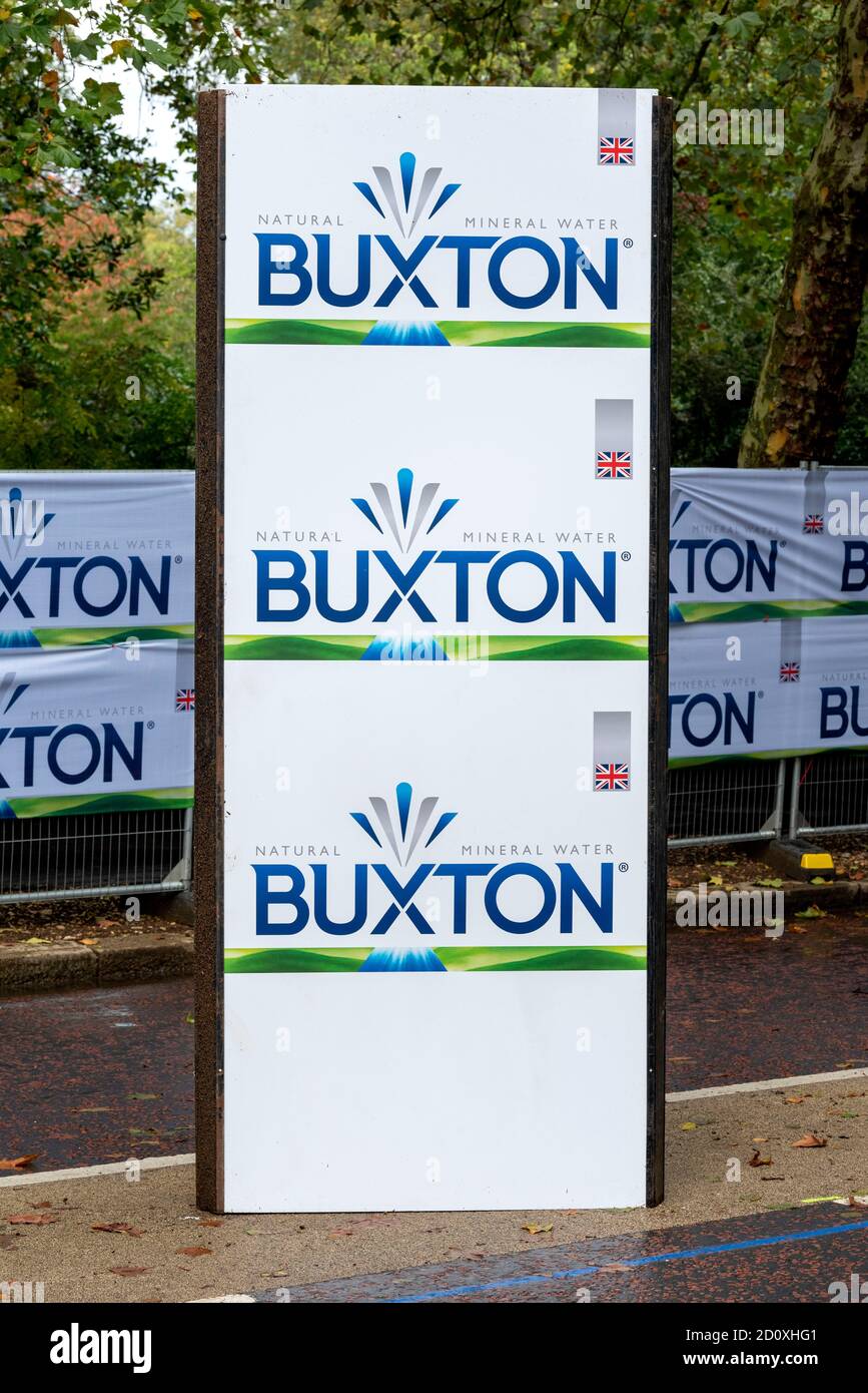 A Buxton sponsorship sign seen on the route of the 40th London Marathon.Only Elite runners will run the course this year with everyone else taking part in a ‘virtual’ marathon. The race will take place on a closed Bio-secure loop circuit around St James’s Park in central London in The Mall, Birdcage Walk & Horse Guards parade. Stock Photo
