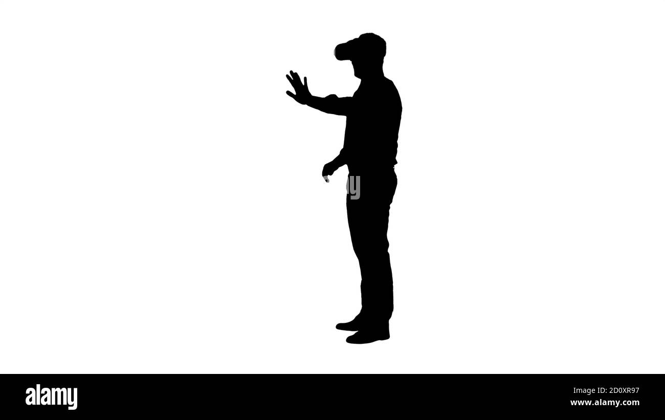 Silhouette Businessman in virtual reality headset walking in virtual world  Stock Photo - Alamy